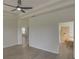 Main bedroom with wood-look floors, ceiling fan and ensuite bathroom at 7110 Moss Ledge Run, Land O Lakes, FL 34637