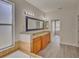 Double vanity bathroom with granite countertops and a large mirror at 7110 Moss Ledge Run, Land O Lakes, FL 34637