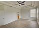 Main bedroom with wood-look floors, ceiling fan and ensuite bathroom at 7110 Moss Ledge Run, Land O Lakes, FL 34637