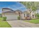 Two-story house with attached garage and manicured lawn at 7110 Moss Ledge Run, Land O Lakes, FL 34637