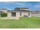 Home features a large backyard with patio and grassy area at 7110 Moss Ledge Run, Land O Lakes, FL 34637