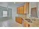Kitchen with granite countertops, double sink, and wooden cabinets at 7110 Moss Ledge Run, Land O Lakes, FL 34637