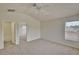 Spacious bedroom with plush carpeting, an ensuite bathroom, and large window at 7110 Moss Ledge Run, Land O Lakes, FL 34637