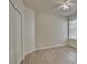 Bedroom with wood-look floors and double door closet at 7110 Moss Ledge Run, Land O Lakes, FL 34637