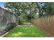 Spacious backyard with grassy area and wooden fence at 4504 W Lamb Ave, Tampa, FL 33629