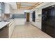 Spacious kitchen featuring white cabinets and a black refrigerator at 4504 W Lamb Ave, Tampa, FL 33629