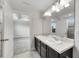 Double vanity bathroom with dark brown cabinets and a large mirror at 9118 Mountain Magnolia Dr, Riverview, FL 33578