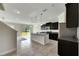 Modern kitchen with dark cabinetry, granite counters, and an island at 9118 Mountain Magnolia Dr, Riverview, FL 33578