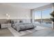 Spacious main bedroom with large window, stylish furnishings and lake view at 1028 Sunset Point Rd # R8, Clearwater, FL 33755
