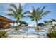 Relaxing resort-style pool with palm trees and lounge chairs at 1028 Sunset Point Rd # R8, Clearwater, FL 33755