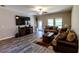 Living room featuring hardwood floors, comfy seating and large TV at 10215 Count Fleet Dr, Ruskin, FL 33573