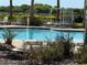 Community pool with lounge chairs and cabana at 10215 Count Fleet Dr, Ruskin, FL 33573