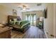 Main bedroom with large bed, plenty of windows and wood floors at 10215 Count Fleet Dr, Ruskin, FL 33573