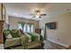Main bedroom with king-size bed, TV and large windows at 10215 Count Fleet Dr, Ruskin, FL 33573