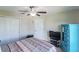 Bedroom with a bed, dresser, and ceiling fan at 10215 Count Fleet Dr, Ruskin, FL 33573