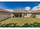 Large backyard with covered patio and grassy area at 10215 Count Fleet Dr, Ruskin, FL 33573
