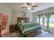 Main bedroom with king-size bed and ensuite bathroom access at 10215 Count Fleet Dr, Ruskin, FL 33573