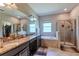 Bathroom with granite countertops, a soaking tub, and a shower at 10215 Count Fleet Dr, Ruskin, FL 33573