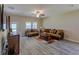 Spacious living room with hardwood floors and a large TV at 10215 Count Fleet Dr, Ruskin, FL 33573