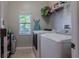 Laundry room with washer, dryer, and overhead shelving at 10215 Count Fleet Dr, Ruskin, FL 33573