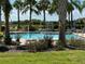 Community pool with lounge chairs and cabana at 10215 Count Fleet Dr, Ruskin, FL 33573