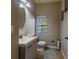 Modern half bathroom with a gray vanity and tiled floors at 10215 Count Fleet Dr, Ruskin, FL 33573