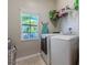 Well-lit laundry room, featuring washer, dryer, and storage at 10215 Count Fleet Dr, Ruskin, FL 33573