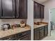 Kitchen features a large pantry with granite countertops at 10215 Count Fleet Dr, Ruskin, FL 33573