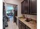 Walk-in pantry with granite countertops and custom cabinetry at 10215 Count Fleet Dr, Ruskin, FL 33573