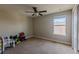 Bright bedroom with ceiling fan, window, and carpet at 10215 Count Fleet Dr, Ruskin, FL 33573