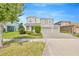 Charming two-story home with a manicured lawn, complemented by a two car garage and beautiful landscaping at 16462 Courtyard Loop, Land O Lakes, FL 34638