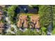 Aerial view highlighting the layout of homes nestled among mature trees and a serene pond with fountain at 4251 Preserve Pl, Palm Harbor, FL 34685