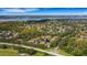 An aerial view of the neighborhood with lush greenery, nearby lake, and a tranquil setting for each home at 4251 Preserve Pl, Palm Harbor, FL 34685