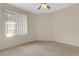 Bright bedroom with neutral carpet, ceiling fan, and large window providing ample natural light at 4251 Preserve Pl, Palm Harbor, FL 34685