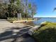 Public boat ramp with wooden railings leads to the lake, providing access for boating and water activities at 4251 Preserve Pl, Palm Harbor, FL 34685