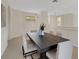 Neutral dining room with large table and six chairs and view to kitchen area at 4251 Preserve Pl, Palm Harbor, FL 34685