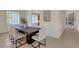 Dining room features a dark wood table and white chairs at 4251 Preserve Pl, Palm Harbor, FL 34685