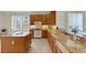 Bright kitchen boasts granite countertops, a center island, and modern white appliances at 4251 Preserve Pl, Palm Harbor, FL 34685