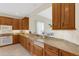 Spacious kitchen with granite countertops, wood cabinetry and stainless dishwasher at 4251 Preserve Pl, Palm Harbor, FL 34685