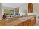 Open-concept kitchen featuring granite countertops and view into adjacent living space at 4251 Preserve Pl, Palm Harbor, FL 34685