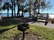 Community outdoor recreation area featuring a BBQ grill with lake views at 4251 Preserve Pl, Palm Harbor, FL 34685