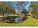 Neighborhood view features a water feature, lush trees and landscaping, and well maintained grounds at 4251 Preserve Pl, Palm Harbor, FL 34685