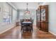 Bright dining room with hardwood floors, a wooden hutch, and a chandelier at 8221 Nectar Ridge Ct, Odessa, FL 33556