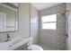 Updated bathroom with modern shower and geometric tile at 12400 Park Blvd # 210, Seminole, FL 33772