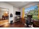 Home office features built-in shelving, hardwood floors, and view of backyard at 4940 Willow Ridge Ter, Valrico, FL 33596