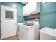 Functional laundry room with washer, dryer, and utility sink at 4940 Willow Ridge Ter, Valrico, FL 33596