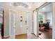 Bright entryway with white door and barn door to home office at 4940 Willow Ridge Ter, Valrico, FL 33596