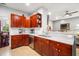 Modern kitchen with granite countertops, stainless steel appliances, and wood cabinets at 4940 Willow Ridge Ter, Valrico, FL 33596