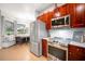 Modern kitchen with stainless steel appliances and wood cabinets at 4940 Willow Ridge Ter, Valrico, FL 33596