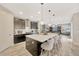 Modern kitchen with island, stainless steel appliances, and white quartz countertops at 16462 Courtyard Loop, Land O Lakes, FL 34638